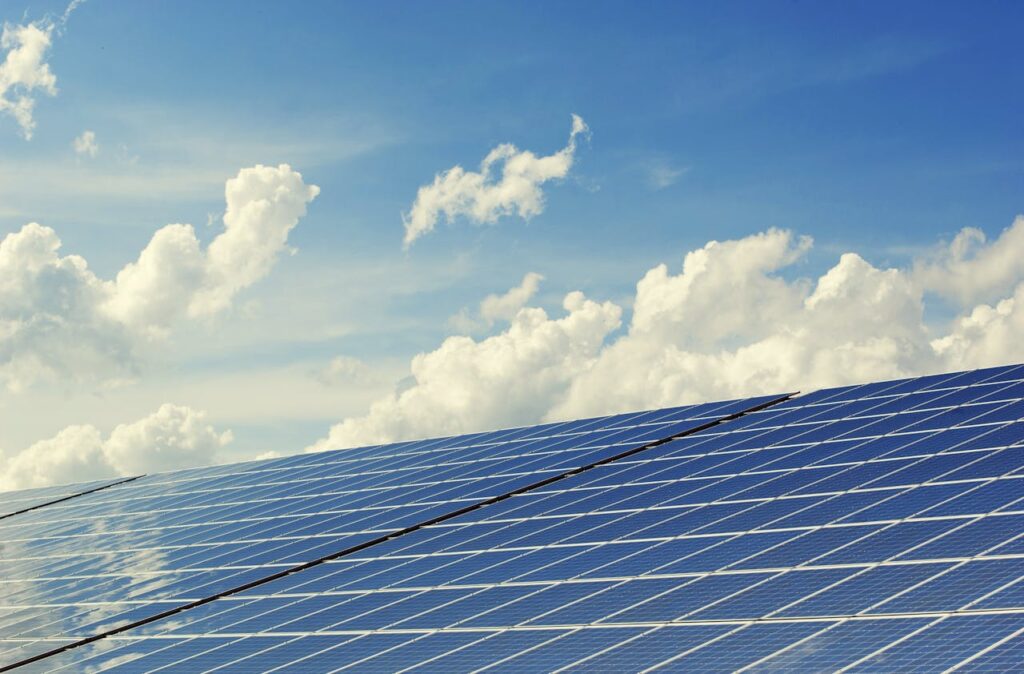 pexels-photo-356036 Sleek modern solar panels under a vibrant blue sky with clouds, symbolizing clean energy.